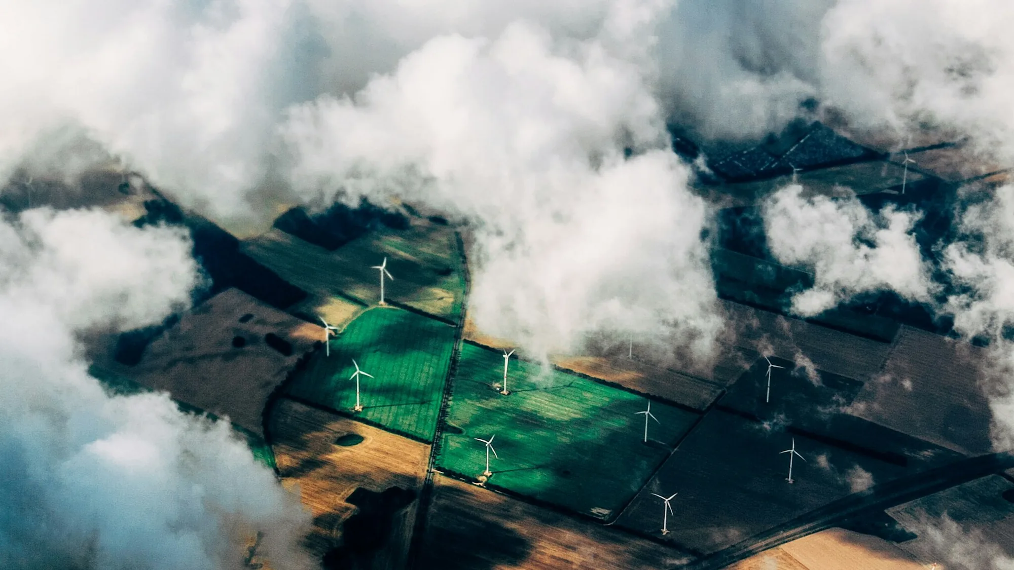 Aerial view of wind turbines across agricultural land, representing renewable energy infrastructure